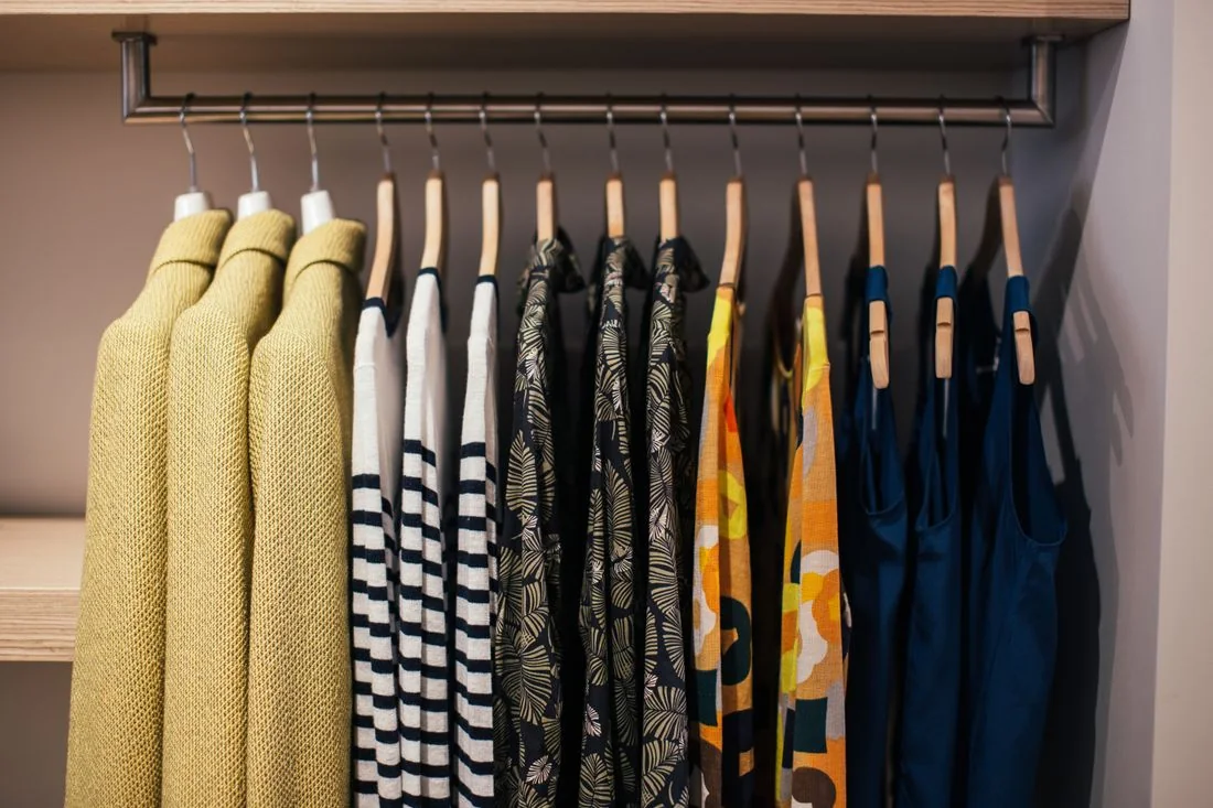 Clothes hanging in an open wardrobe