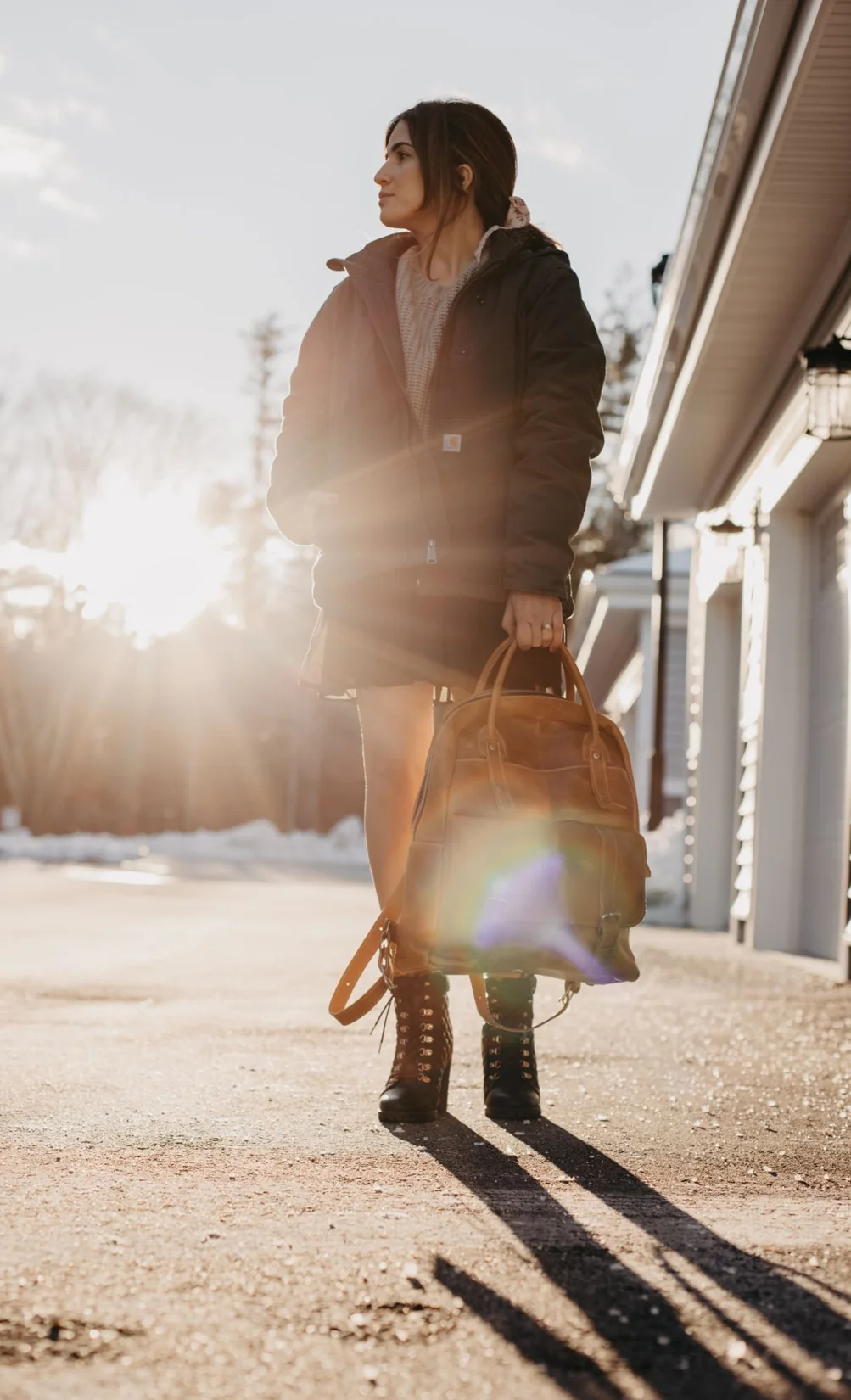 Woman carrying a bag while standing on a city street