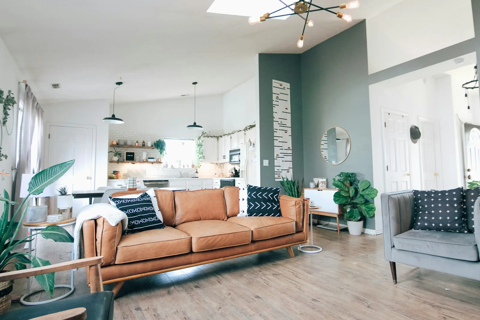 Brown leather sofa and houseplants in a bright living room